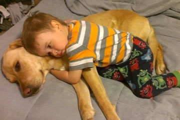 Un petit garçon et son chien sont inséparables